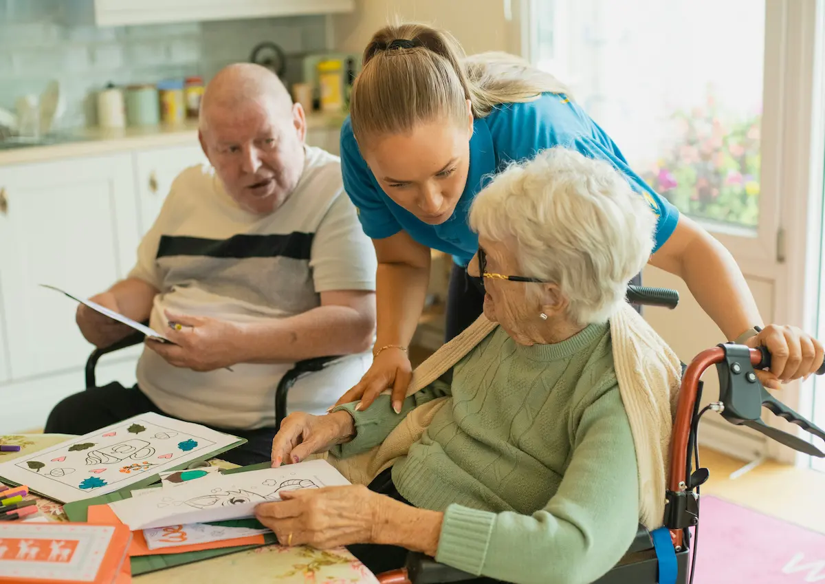 Caregiver and residents enjoying a craft activity together